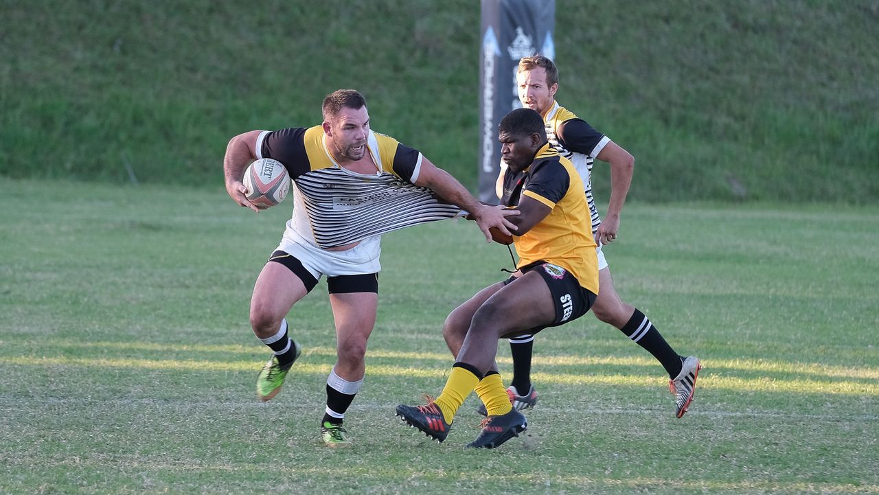 Intense rugby match in South Africa showcasing teamwork and competition on a sunny day.